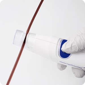 close-up of the top of the sealer as it seals a tube containing blood