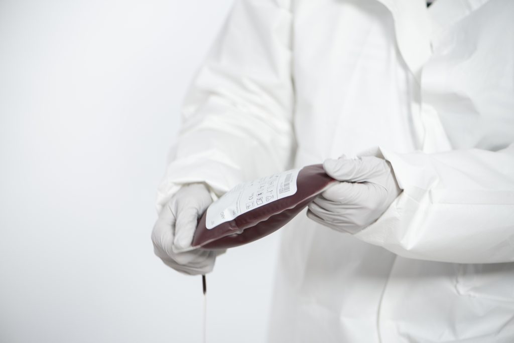 blood safety represented by a lab technician holding a blood bag